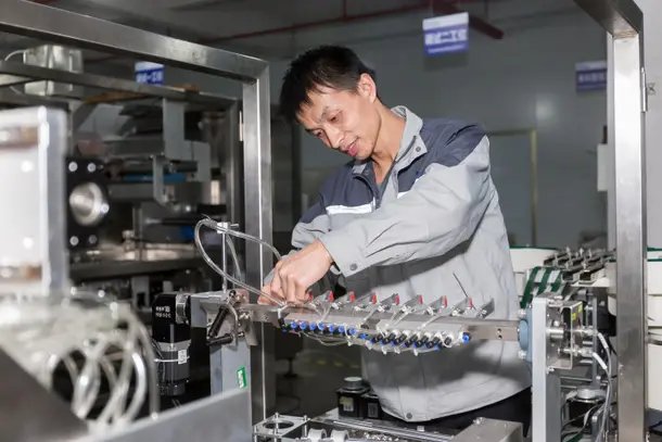 Technician adjusting a production machine